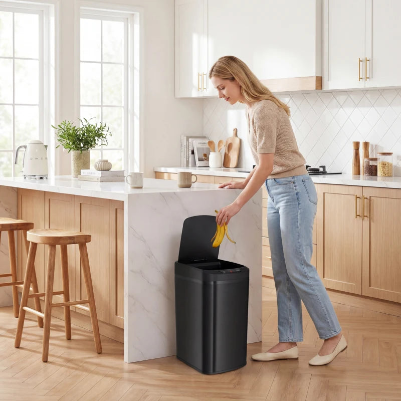 Black 12L touchless sensor trash bin standing in kitchen setting