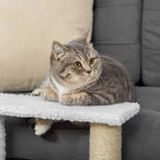 Grey cat resting on top plush platform of a white 3-step cat stair with sisal post