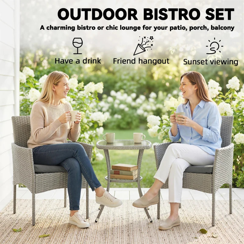 Outdoor dark grey rattan bistro set with two armchairs and a two-tier glass table