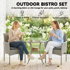 Outdoor dark grey rattan bistro set with two armchairs and a two-tier glass table