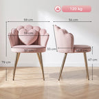 Pink velvet armchair with curved armrests, heart pillow, and gold-tone metal legs