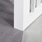 White raised dog feeding stand base on gray floor with stainless bowls above