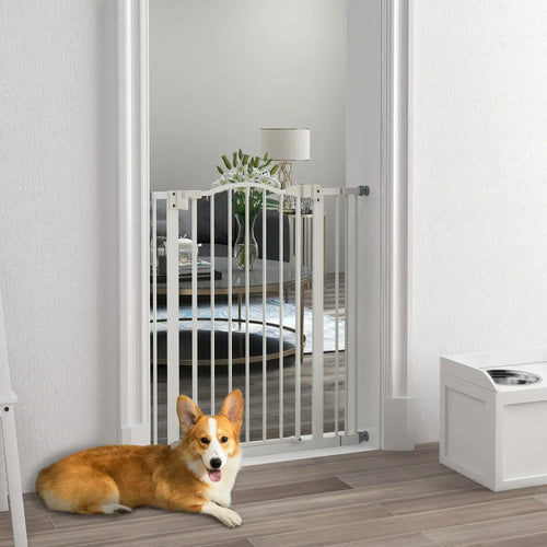 White metal dog safety gate installed in doorway with floor stopper for pets