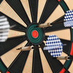 Bullseye close-up on electronic dartboard with darts, green center ring and red inner target