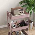 Pink three-tier steel storage trolley with raised edges and rounded handles