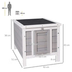 Grey wooden outdoor hutch with front door openings, side walls, and attached lower ramp