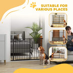 Black pet safety gate set up in a home entryway, with a dog behind the bars