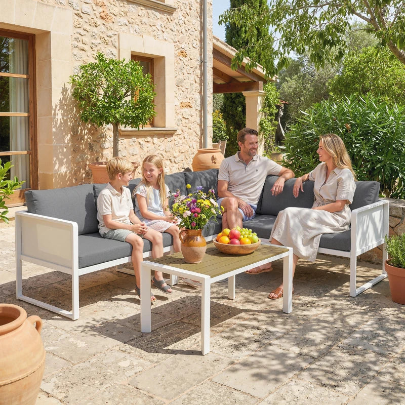 Grey corner sofa set with white frames and faux-wood table on outdoor patio