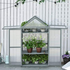 Grey greenhouse cold frame with double doors open, showing plants on shelves