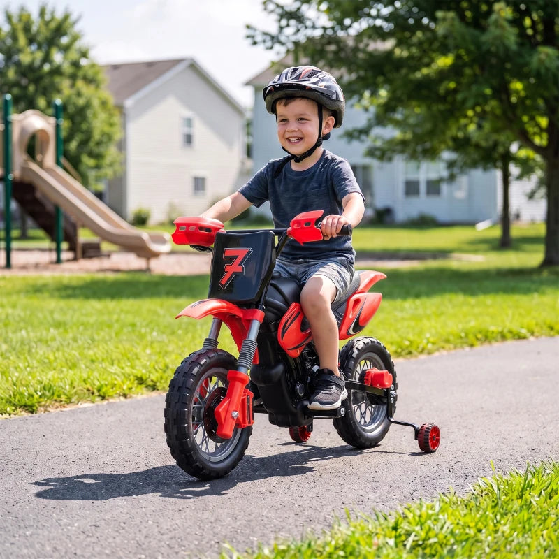 Red kids electric motorbike with training wheels, ridden by a child on a path