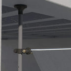 Dark grey awning roller assembly with manual crank and fabric edge close-up