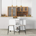 White drop-leaf dining table with two open side storage shelves and four rolling stools