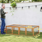 Wooden rabbit hutch with wire mesh walls and open top run, viewed full length