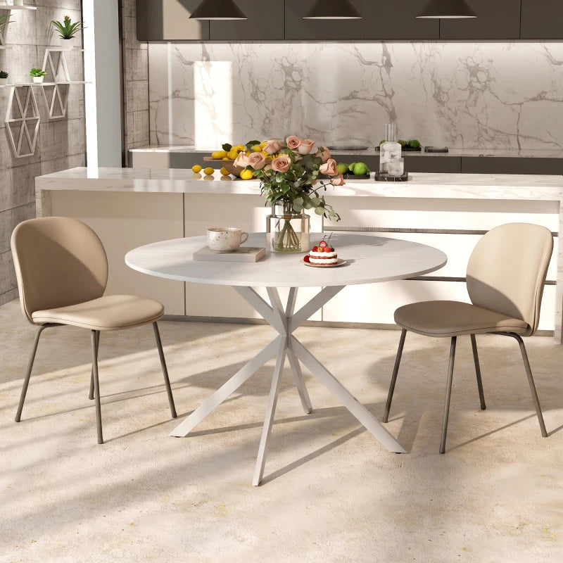 White round dining table with steel legs and four upholstered chairs