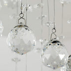 Faceted clear crystal glass ball pendants hanging from thin metal loops