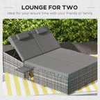 Grey two-seater rattan day bed with padded cushions and two support backrest sections