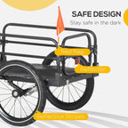 Black bicycle trailer with red flag, reflector, and reflective stripes on wheel guards