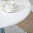 White glossy round tabletop edge of bar table with silver pedestal support