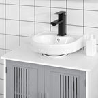 Grey under-sink cabinet with two slatted doors beneath a countertop sink.