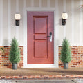 Two artificial cypress trees with green foliage in gray textured pots, entryway pair