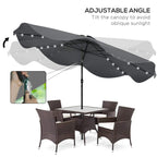 Adjustable dark grey patio umbrella with LED string lights over patio dining set