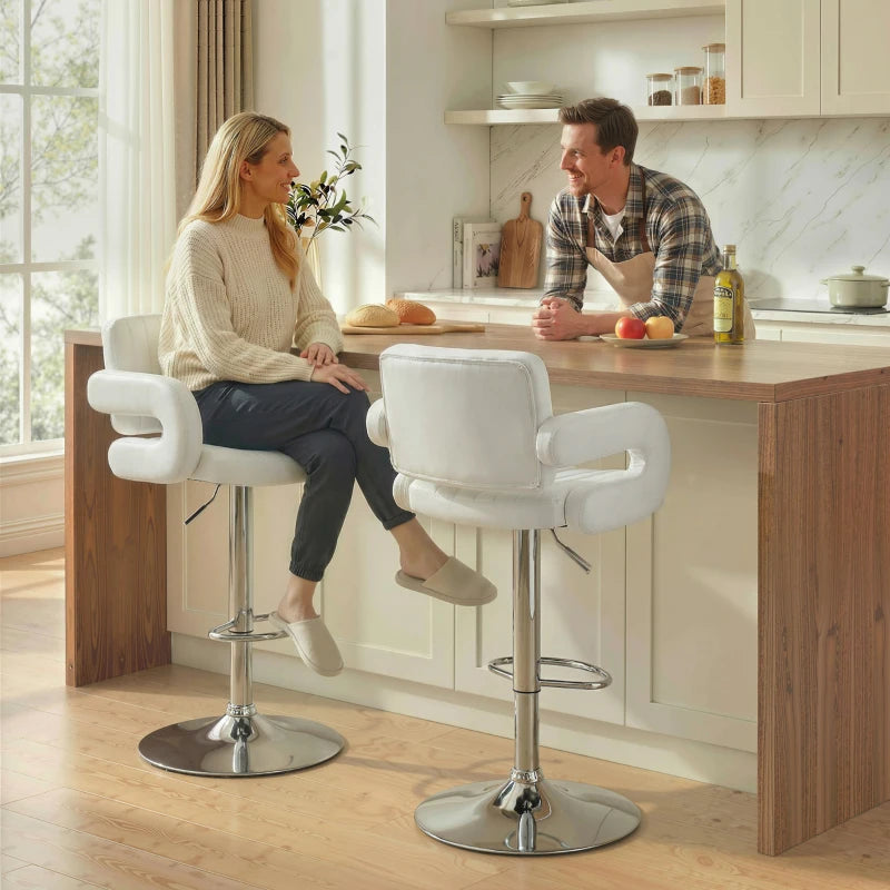 White bar stool with padded backrest and armrests, chrome swivel base at kitchen counter