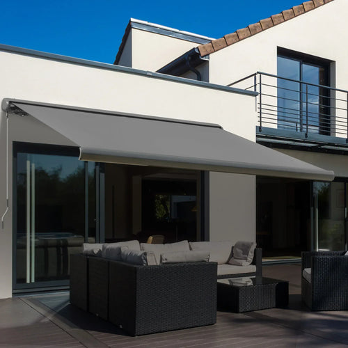 Grey electric awning mounted over patio doors with canopy extended