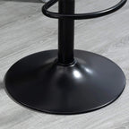 Black round base of a bar stool with central support pole