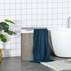 Grey laundry hamper with lid and string handle, with blue towel hanging over the side
