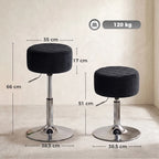 Two black round adjustable swivel bar stools with chrome pedestal bases