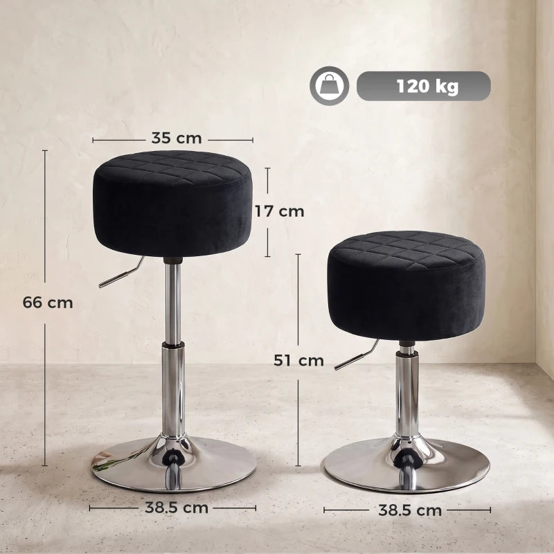 Two black round adjustable swivel bar stools with chrome pedestal bases