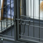 Dark grey metal kennel front safety latch with loop-style lock on the wire door