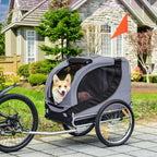 Grey and black dog bike trailer with open mesh front door and dog inside