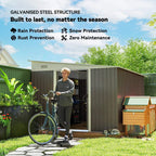 Grey metal garden storage shed with double sliding doors, exterior view