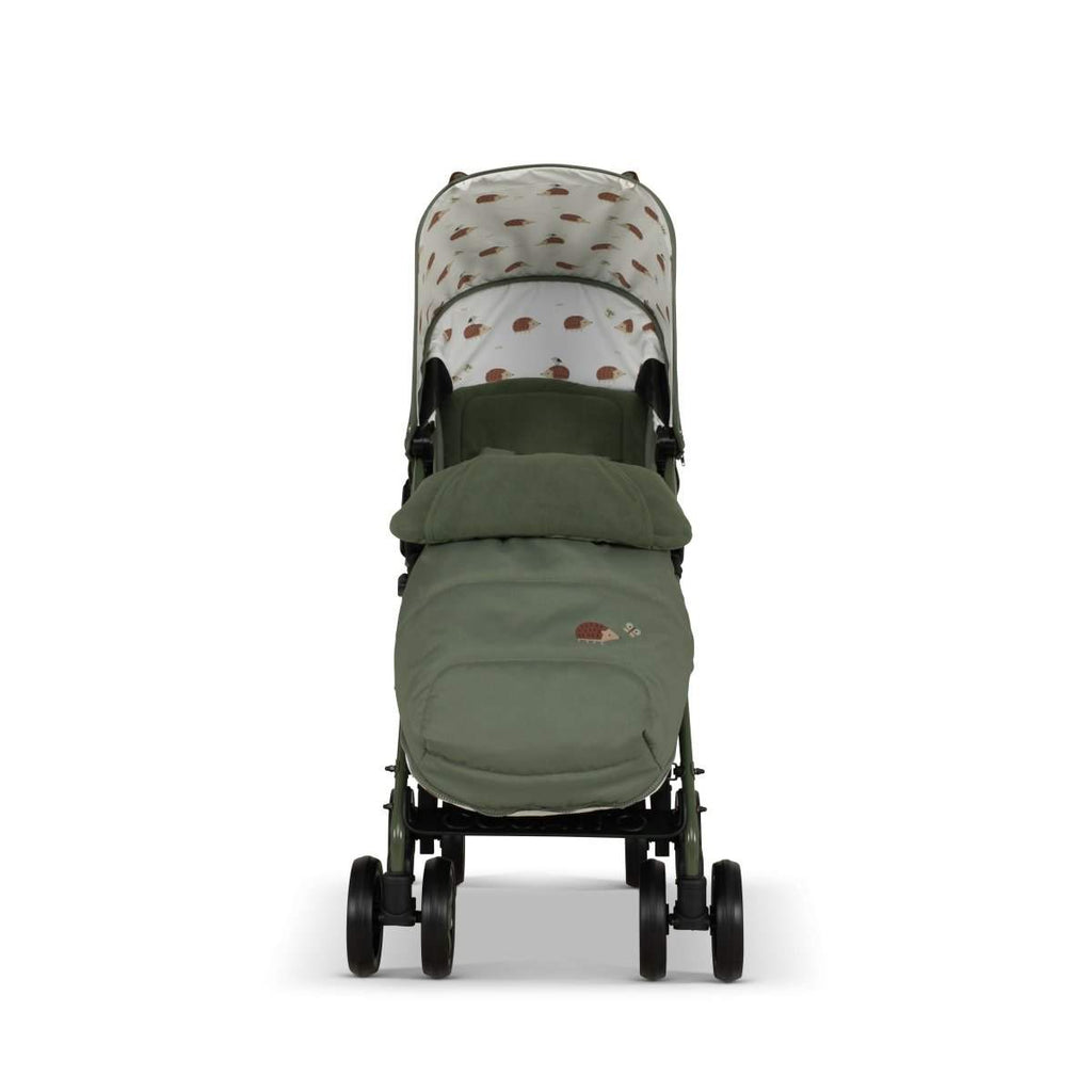 Green stroller with cream hedgehog-print seat liner and dark stroller frame