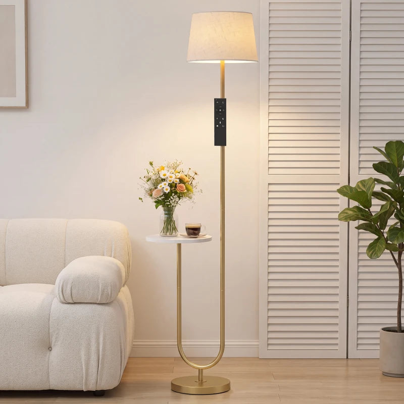 Gold-tone floor lamp with linen shade and small side shelf on round base