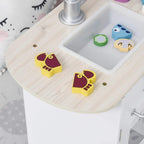 White play kitchen sink area with wooden countertop and small food accessories