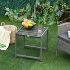 Grey rattan end table beside patio seating, with glass top