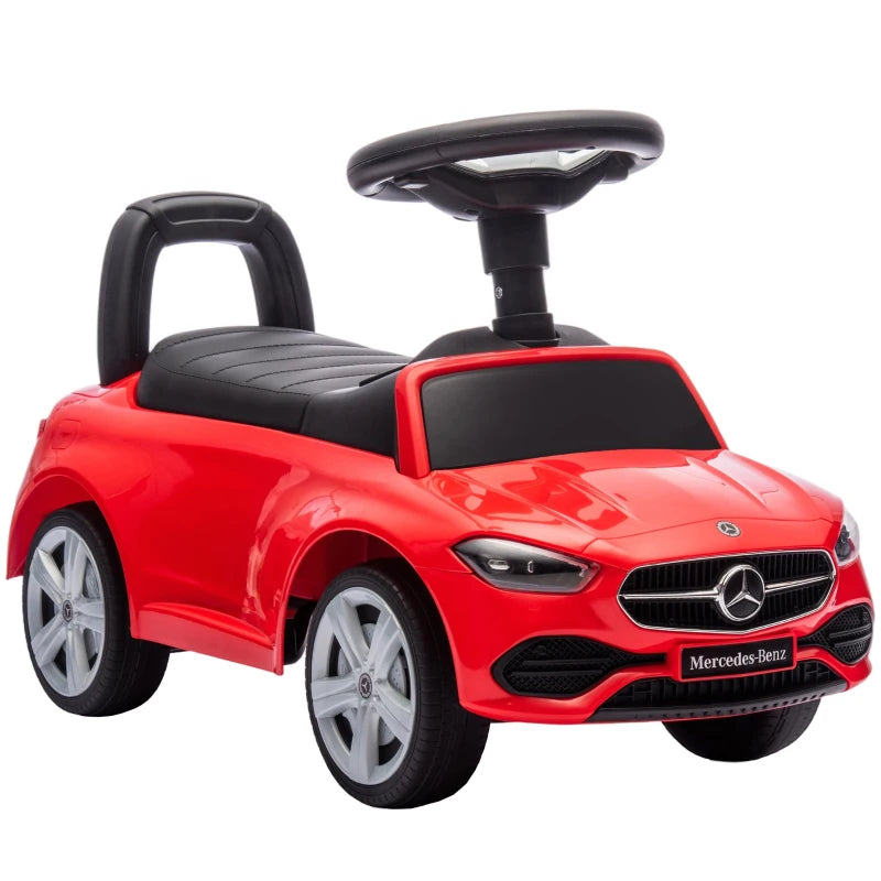 Red Mercedes-Benz ride-on car with black seat and steering wheel, front view