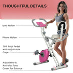 Folding exercise bike with phone and iPad holders, pink flywheel, anti-slip pedals